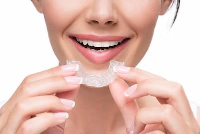 girl holding invisalign braces in murphy tx